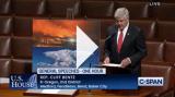 Congressman Bentz Speaking in House Chamber with photo displayed of fires and smoke filled sky
