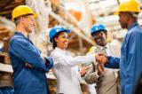 Warehouse manager shaking hands with warehouse worker